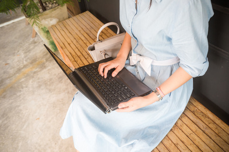 Close up on hand of women use laptop while sitting in cafeの写真素材