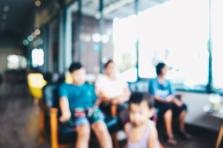 Blurred coffee shop modern cafe with sofa and people bokeh blurの写真素材