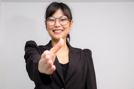 Business smiling women gesture hand shake on white backgroundの写真素材