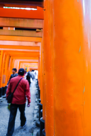 People walk in Red tori gate at Fuchimi Inari Shrine temple sightseeing of Kyoto Japan blurred peopleのeditorial素材