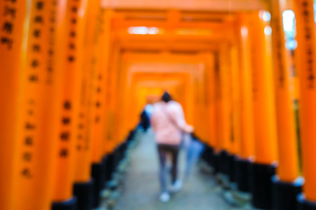 People walk in Red tori gate at Fuchimi Inari Shrine temple sightseeing of Kyoto Japan blurred peopleのeditorial素材