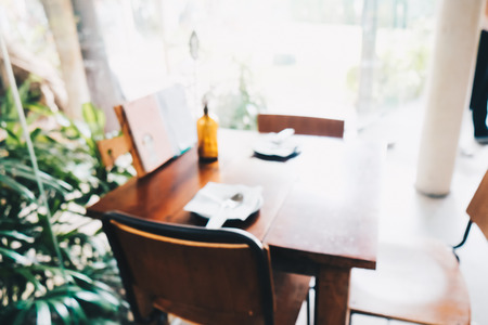 Blurred art wood cafe with chair and table food and drink backgroundの写真素材