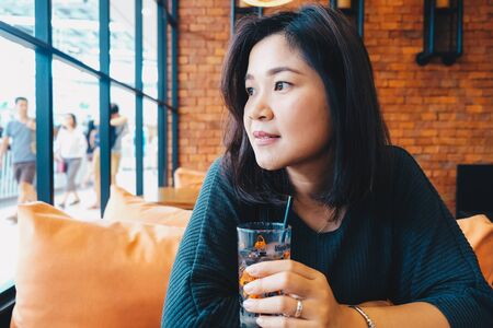 Women drinkking water in cafe art buildingの写真素材