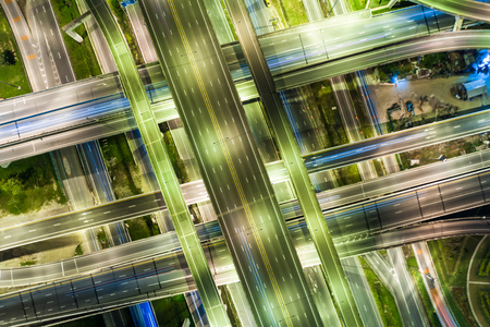 Aerial view night city traffic freway intersection road long exposer imageの写真素材