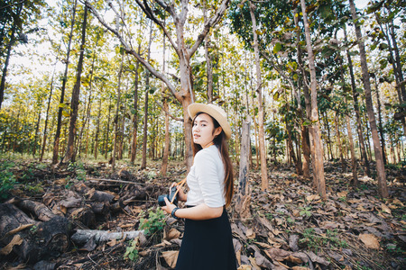 Freedom hipster girl travel in forest with mirrorless camera, Nerd asian woman