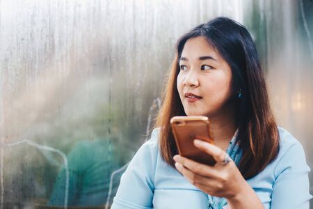Social netwoek girl use smartphone looking for information in cafe