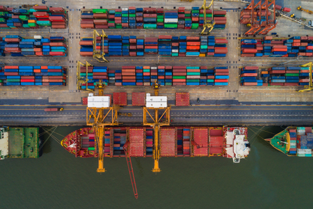 Cargo with container ship in dock at port, Aerial view of transport pierの写真素材