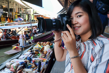 Women take photo travel in floating market, Thailandの写真素材