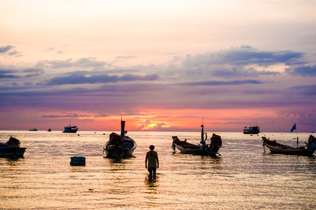 Silhouette sunset with boat on sea beach, Summer seascapeの写真素材