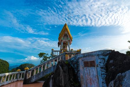 Golden statue on mountain sunruse with fog landscapeの写真素材
