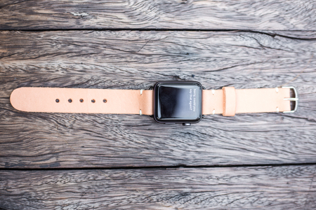 Smart watch leather strap on wood table handmade strapの写真素材