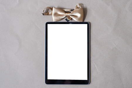 Bowtie with tablet screen on brown paper gift for you conceptの写真素材