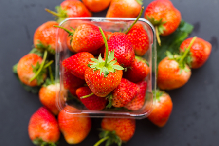Fresh strawberry red fruit on black plate background, Vitamin fruitの写真素材