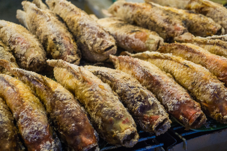 Fired fish with salt in night market, food and drink conceptの写真素材