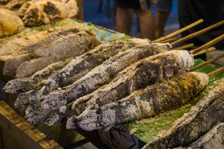 Fired fish with salt in night market, food and drink conceptの写真素材