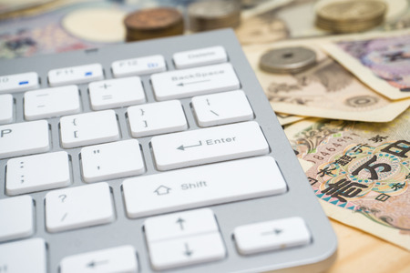 Japanese note bill with computer keyboard, Business technology conceptの写真素材