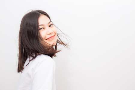 Beautiful young asian women smiling on white background studio shotの写真素材
