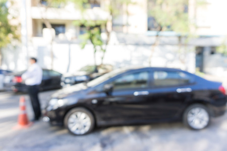 Outdoor blurred car parking background with modern building, TRansport conceptの写真素材