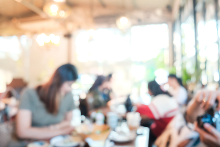 Blurred background of people talking together in art coffee shop restaurant conceptの写真素材
