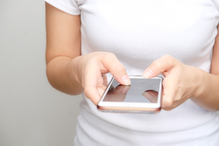 Business asian white shirt women using text on smartphone on white backgroundの写真素材