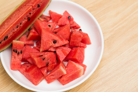 Slice fresh watermelon in disk on wood background, Summer tropical fruitの写真素材
