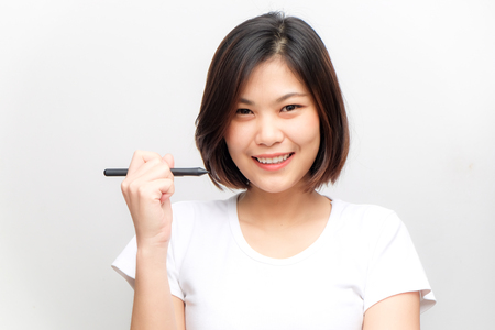 Asian business beauty fashion women hold pen on white background and white shirtの写真素材
