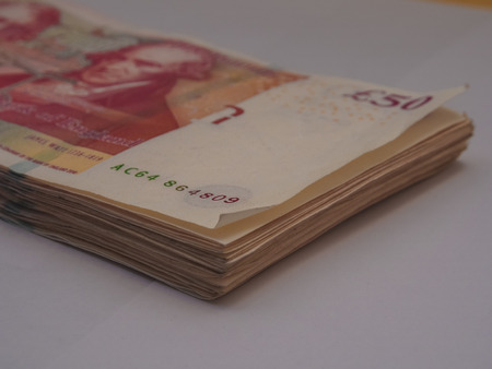 Pile of pound GBP money on white background financial conceptの写真素材
