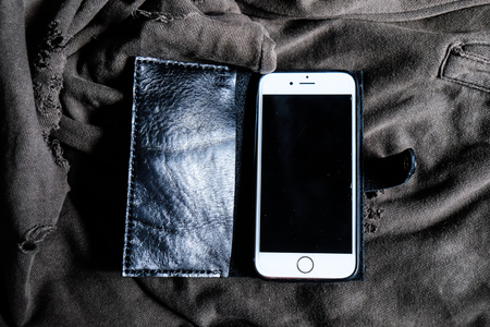 Leather phone case craftsmanship work on cloth background