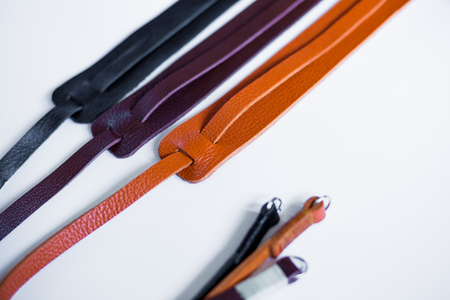 Leather mirrorless camera strap with thread handmade work on white backgroundの写真素材