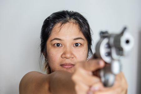 Women shooting target with .357 .44 magnum revolver gun on white backgroundの写真素材