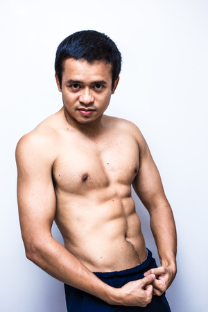 Smart and strong asian muscle man posting on white background lean body healthy conceptの写真素材