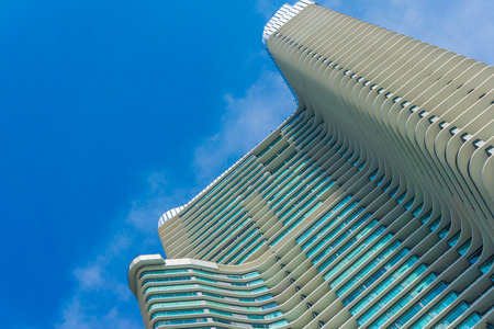 High rise skyscraper modern building against blue sky background looking from belowの写真素材