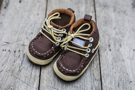 Denim texture of kids vintage shoe on wood backgroundの写真素材