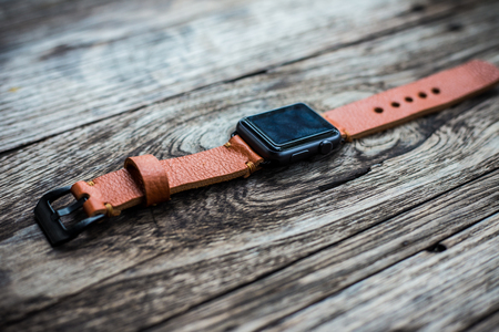 Handmade brown leather vintage watch strap craftsmanship on wood backgroundの写真素材