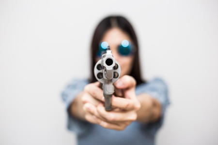 Sexy asian women holding revolver magnum gun on white backgroundの写真素材