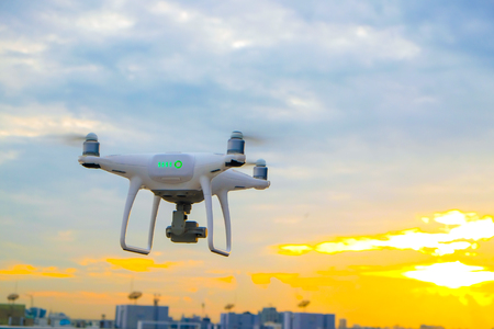 Drone flying on sunset sky in city building, Innovation photography