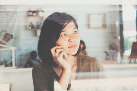 Smart business asian women using cellphone while sitting in cafe, Communication businessの写真素材