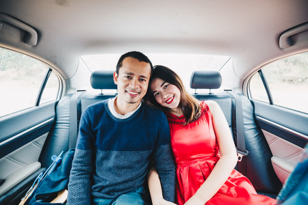 Romantic couple of love travel in modern car while honeymoon tripの写真素材