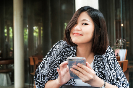 Business asian women using smartphone sitting in cafe, Telecommunication conceptの写真素材