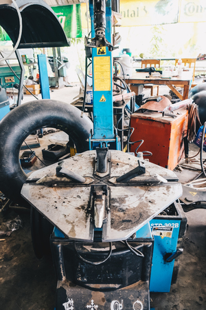 Technician repair tire man fix wheel of car in garageのeditorial素材