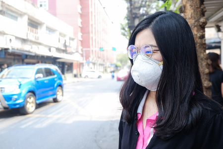 Women wearing protective mask n95 suffering air pollution on street, Air pollution in cityの写真素材