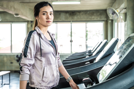 Sport asian women running on treadmill in gym, Healthy lifrstyle