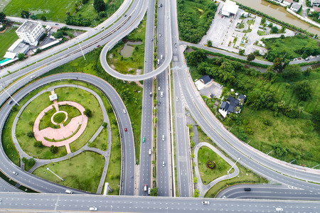 Aerial view intersection road in rural city with green rice field