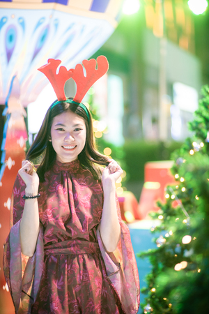 Merry christmas pine tree with beautiful asian women Santa costumeの写真素材
