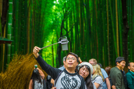 Kyoto Japan - April 8, 2017: Tourist travelling in The Bamboo Forest of Arashiyama enjoying take photo of sightseeing place in Japanのeditorial素材