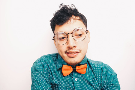 Asian hipster art man with red love bow tie on white backgroundの写真素材