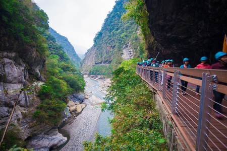 TAROKO NATIONAL PARK, TAIWAN - MARCH 22, 2015: Tourists enjoy walking along Swallow Grotto (Yanzikou) Trail at Taroko National Park, Taiwanのeditorial素材