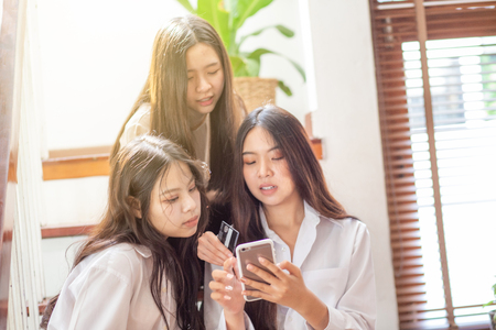 Group of business asian women discussion using smartphone in home officeの写真素材