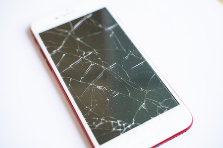 Smartphone screen cracked mobile fix shop concept on white backgroundの写真素材