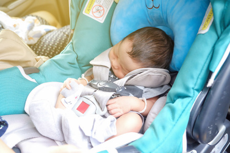 Mom with infant child boy inside savfty car seat go to hospitalの写真素材